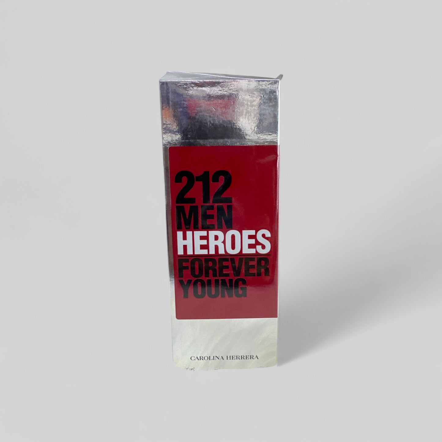 Perfume bottle labeled '212 Men Heroes Forever Young' by Carolina Herrera on a light gray background