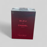 Red box of Bleu de Chanel perfume on a light gray background