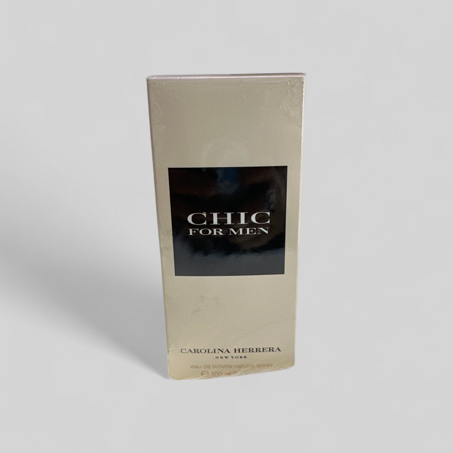 Carolina Herrera Chic for Men perfume packaging on a light gray background