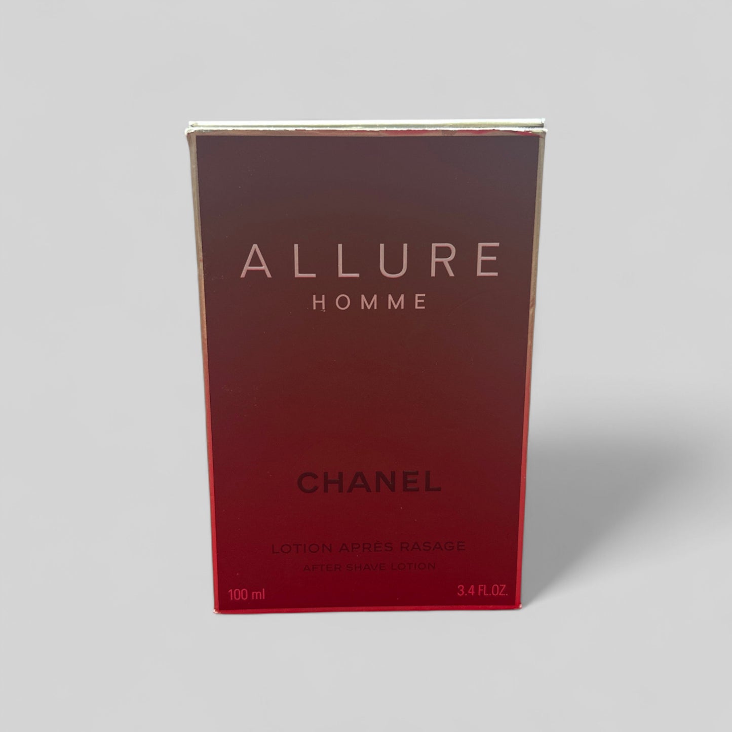 Chanel Allure Homme perfume box on a gray background