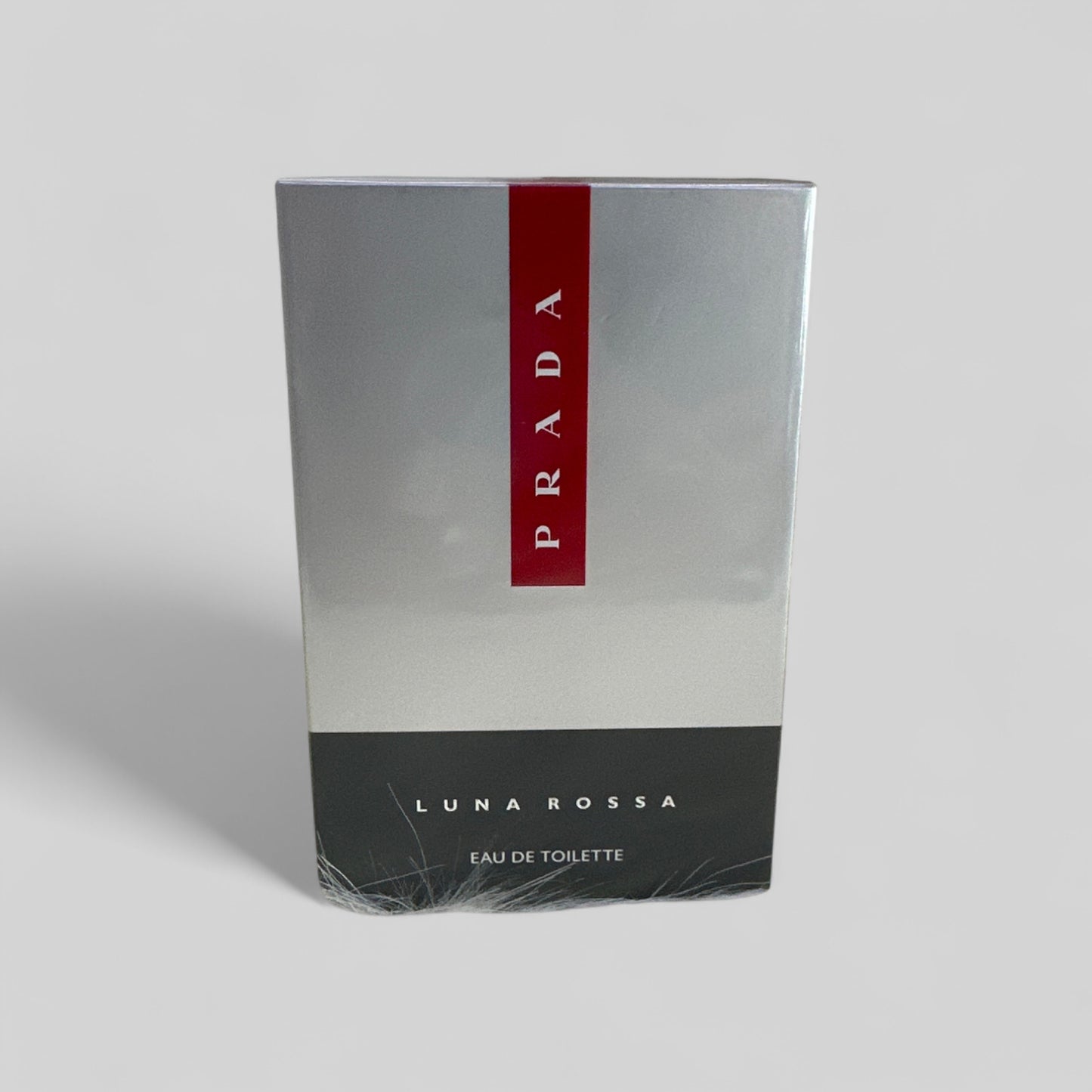 Prada Luna Rossa Eau de Toilette packaging on a light gray background