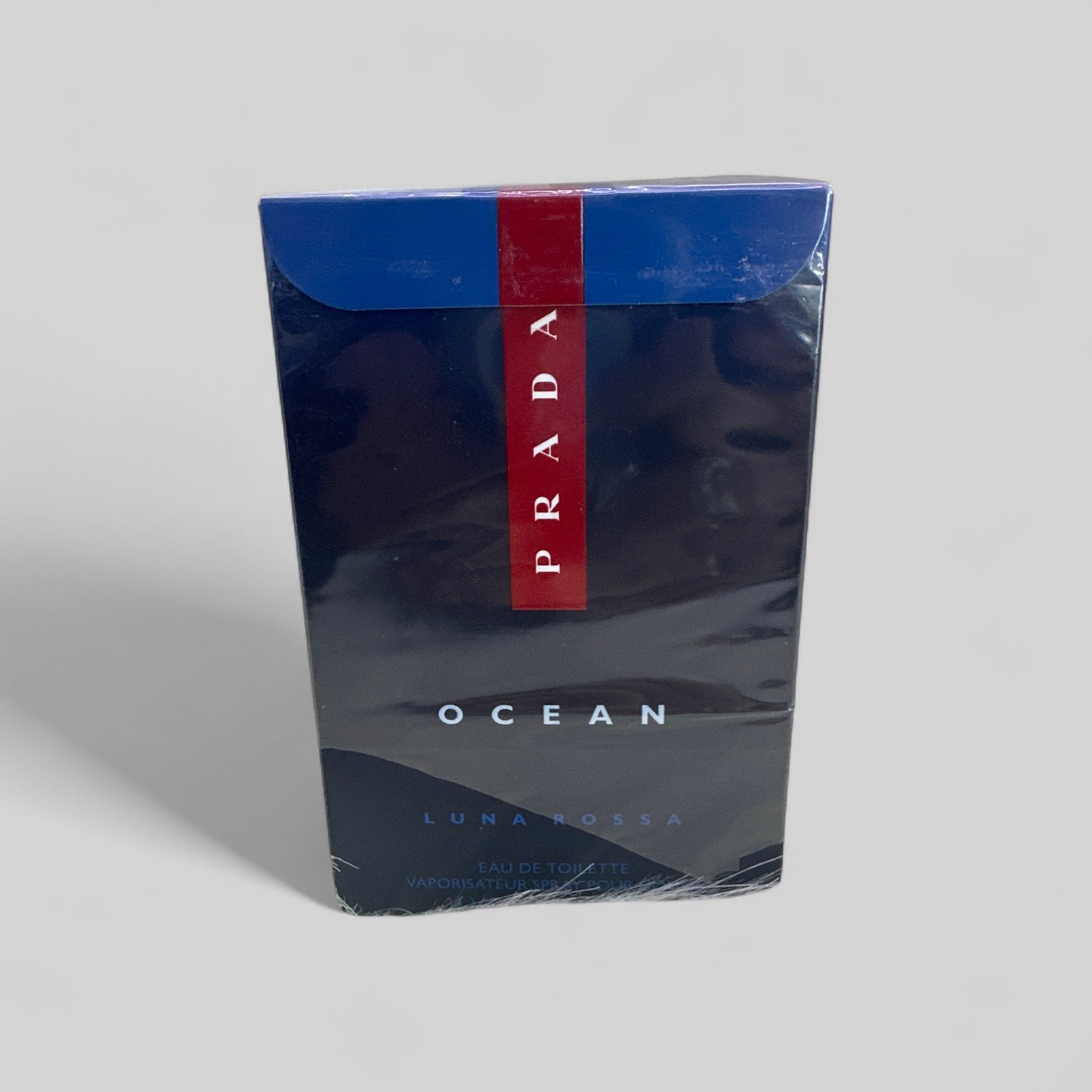 Prada Luna Rossa Ocean packaging on a gray background