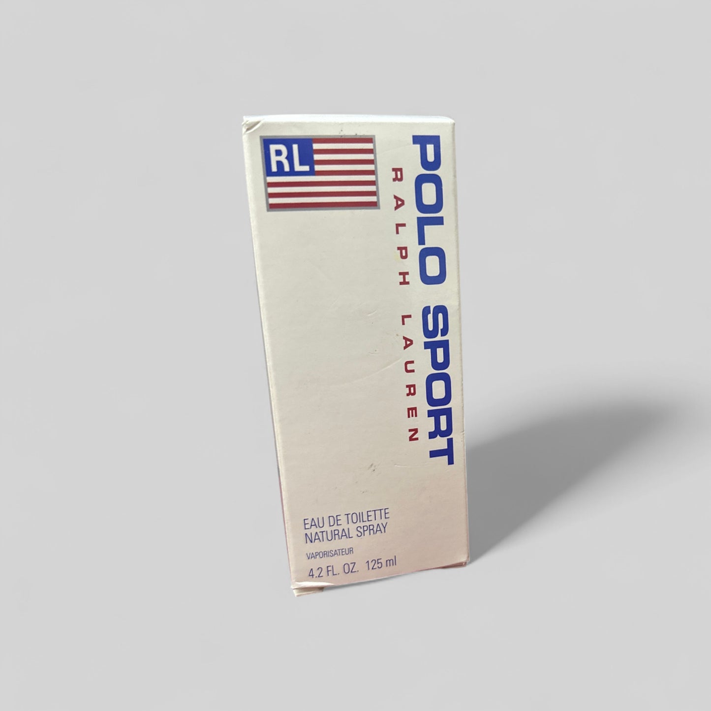 Ralph Lauren Polo Sport eau de toilette packaging on a gray background