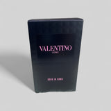 Black packaging box with 'Valentino Uomo' branding on a gray background