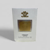 Creed perfume packaging with gold emblem on a white background