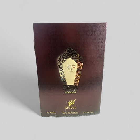 Afnan Eau de Parfum packaging with gold design on a dark brown background