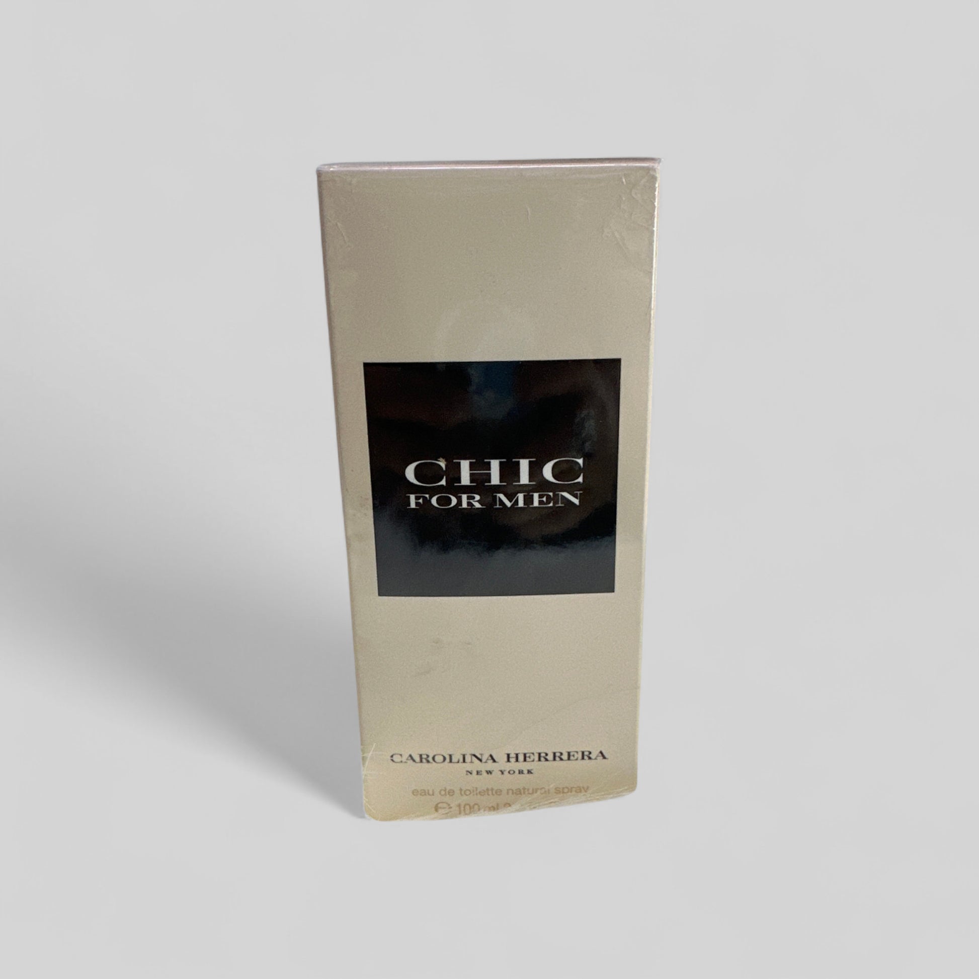 Carolina Herrera Chic for Men perfume packaging on a light gray background