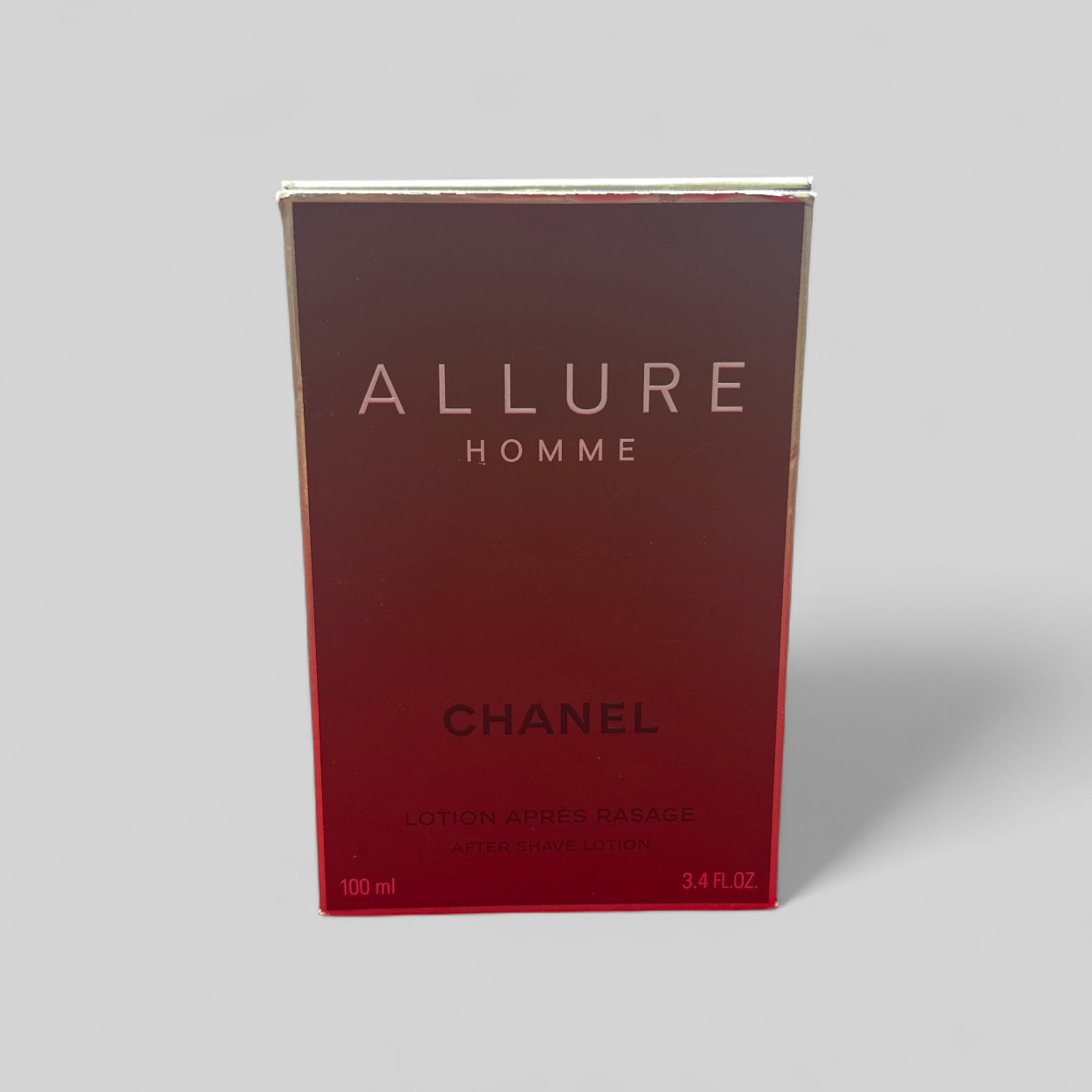 Chanel Allure Homme perfume box on a gray background