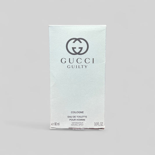 Gucci Guilty cologne packaging on a gray background
