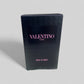 Black packaging box with 'Valentino Uomo' branding on a gray background